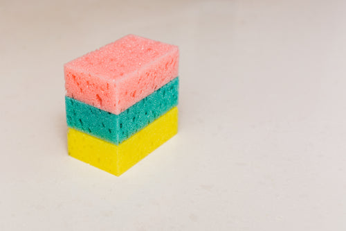 pink green and yellow cleaning sponge