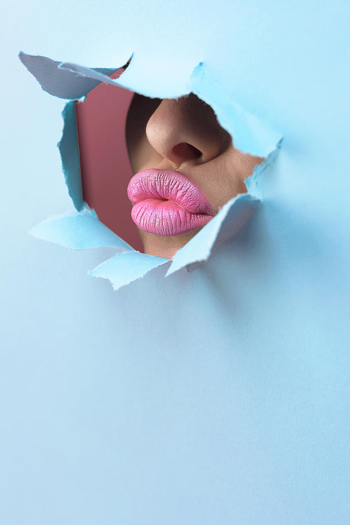 pink lipstick through bright blue paper