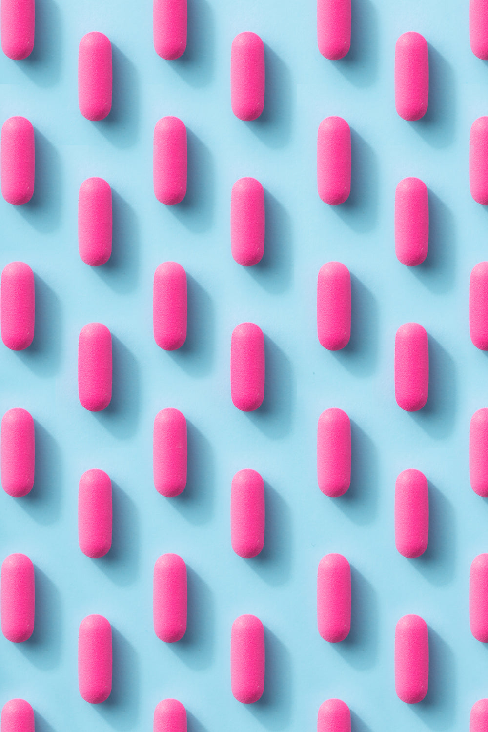 pink pill pattern on a blue background