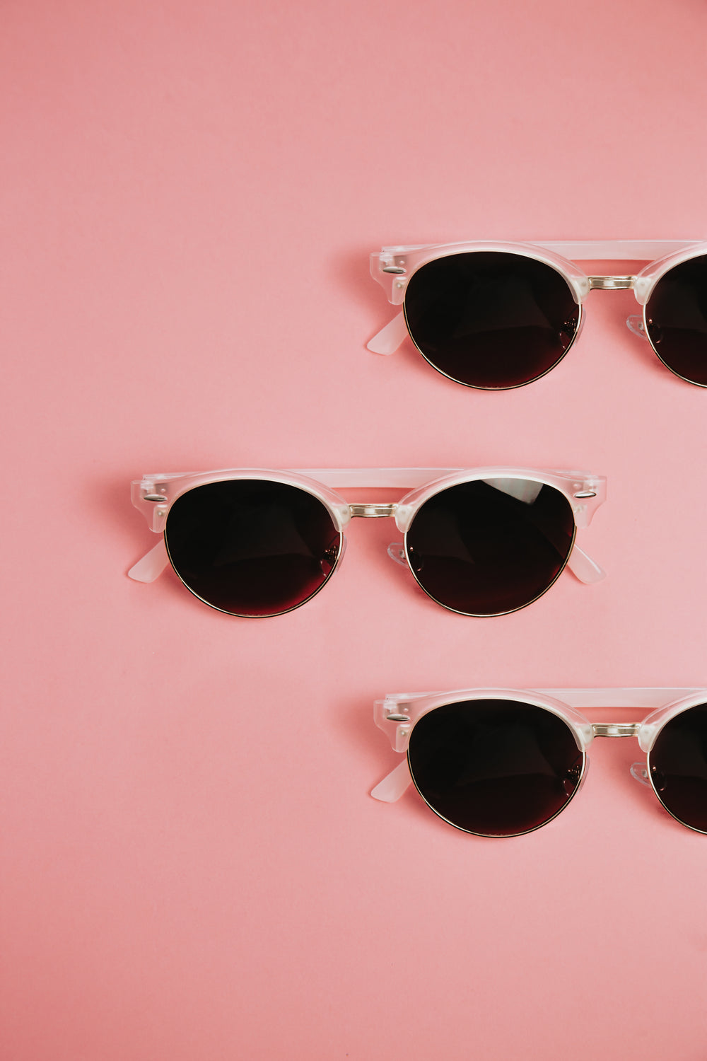pink sunglasses on a pink surface