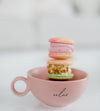 pink teacup filled with macarons