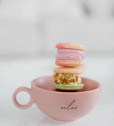 pink teacup filled with macarons