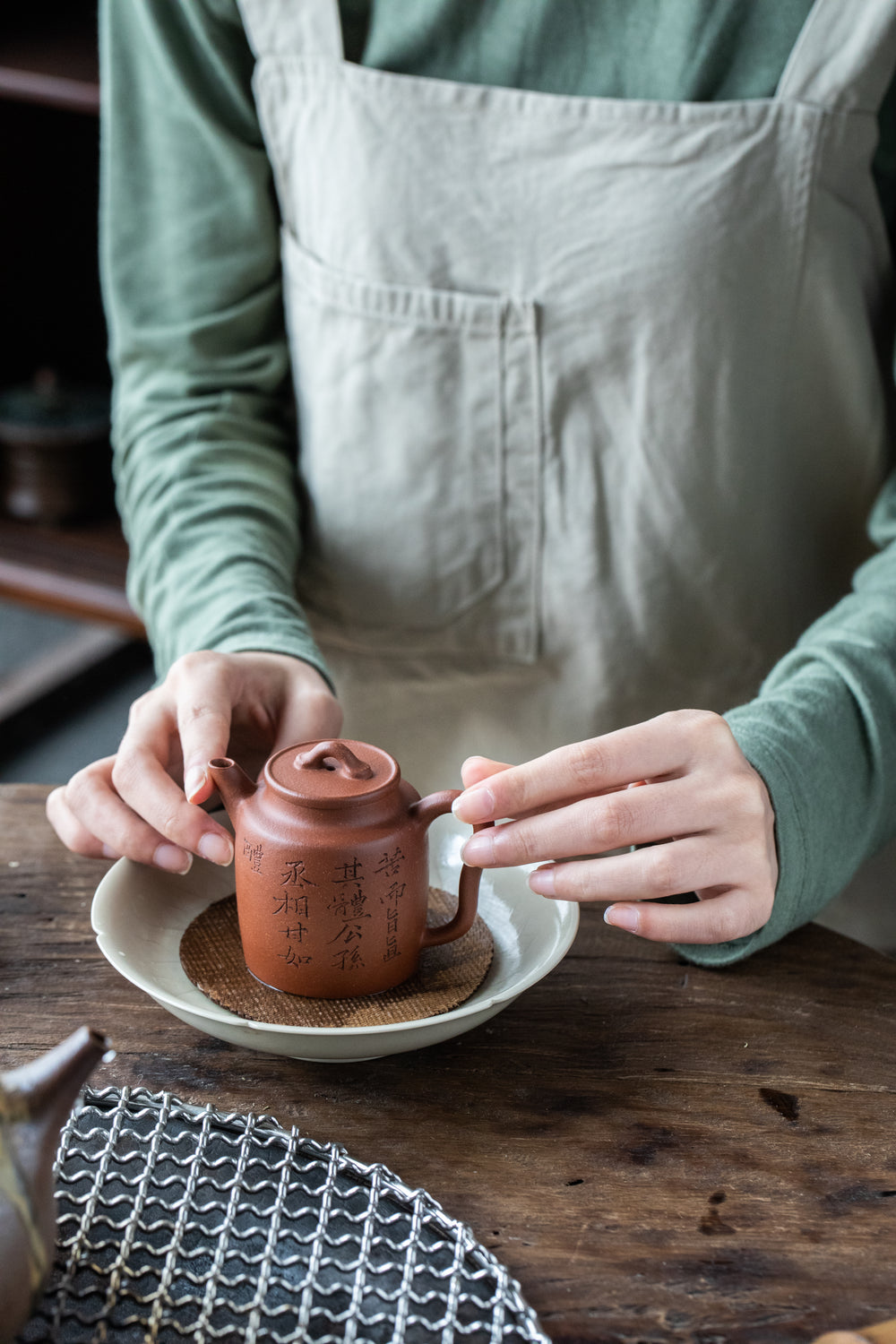 placing ceramic teapot within white bowl