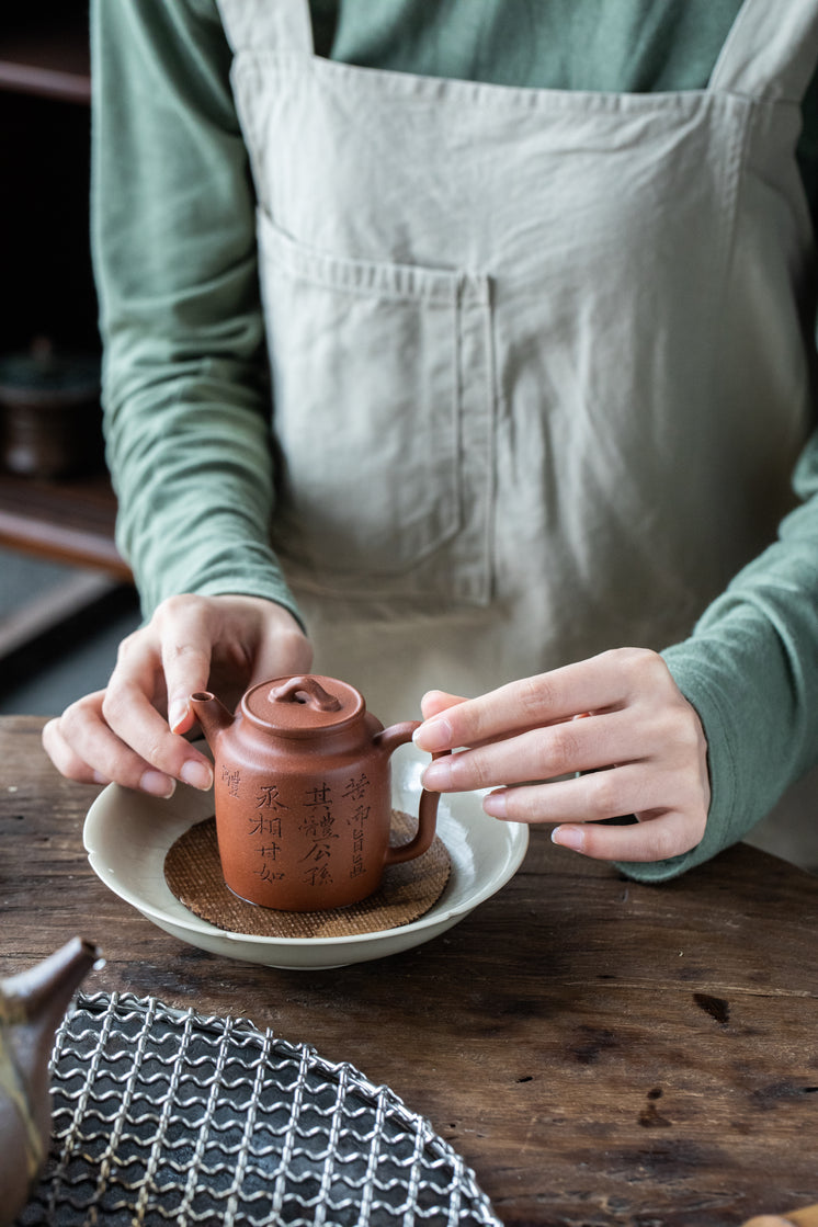 Placing Ceramic Teapot Within White Bowl