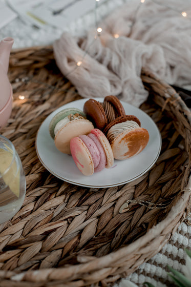 plate of macarons on a wicker tray