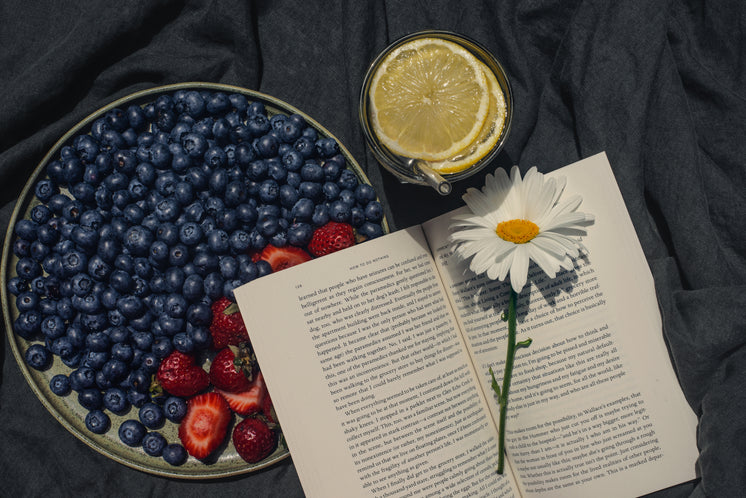 Plate Of Summer Fruit With Drink And An Open Book