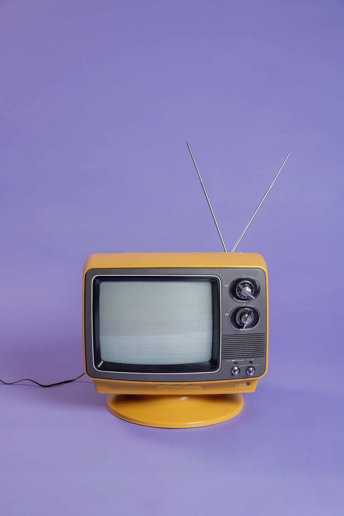 plugged in vintage tv on purple infinity background
