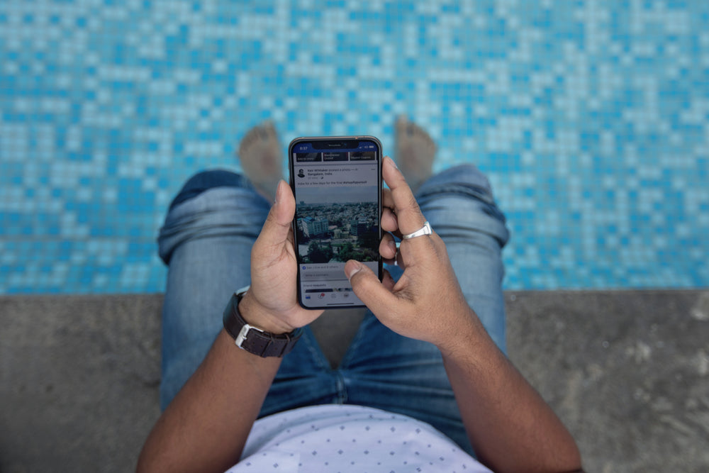 poolside using smart phone