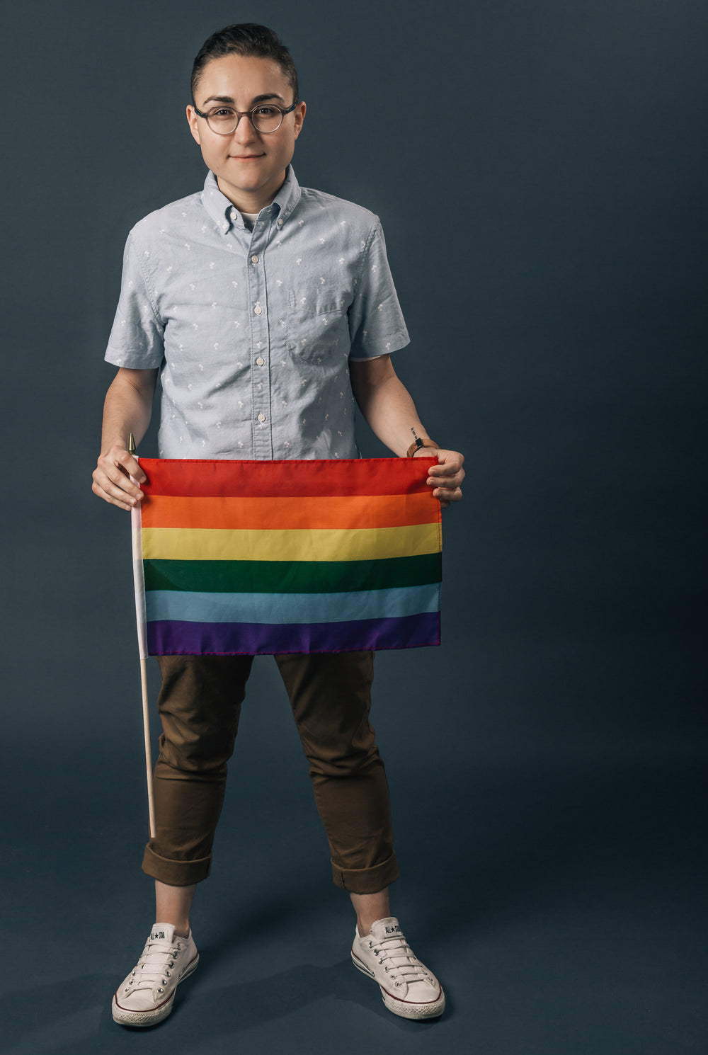 portrait holding a small pride flag