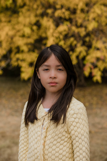 portrait of a child in a yellow sweater