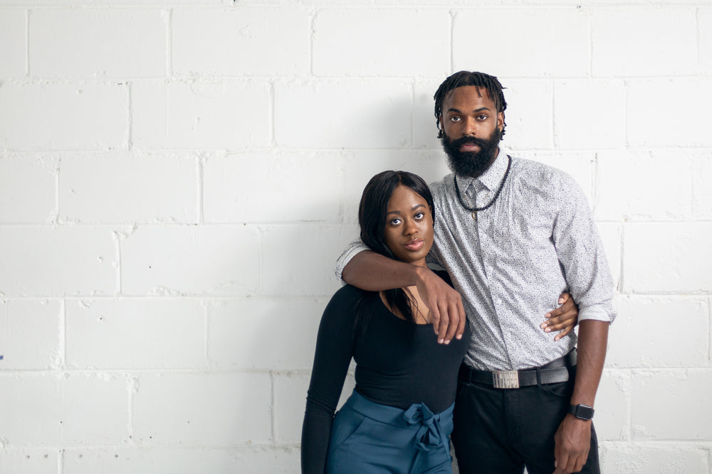 portrait of a man and women against a white wall