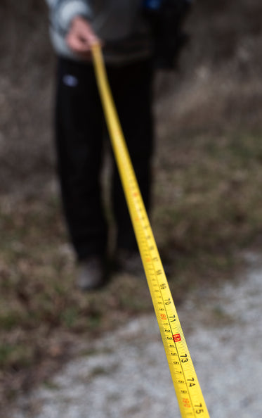 portrait of a person holding a tape measure