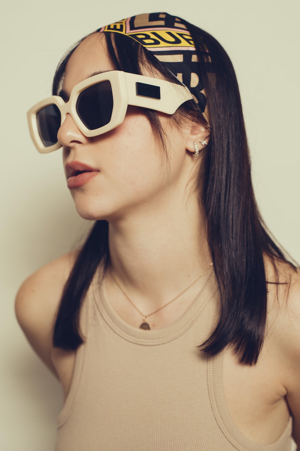 portrait of a woman wearing bold white sunglasses