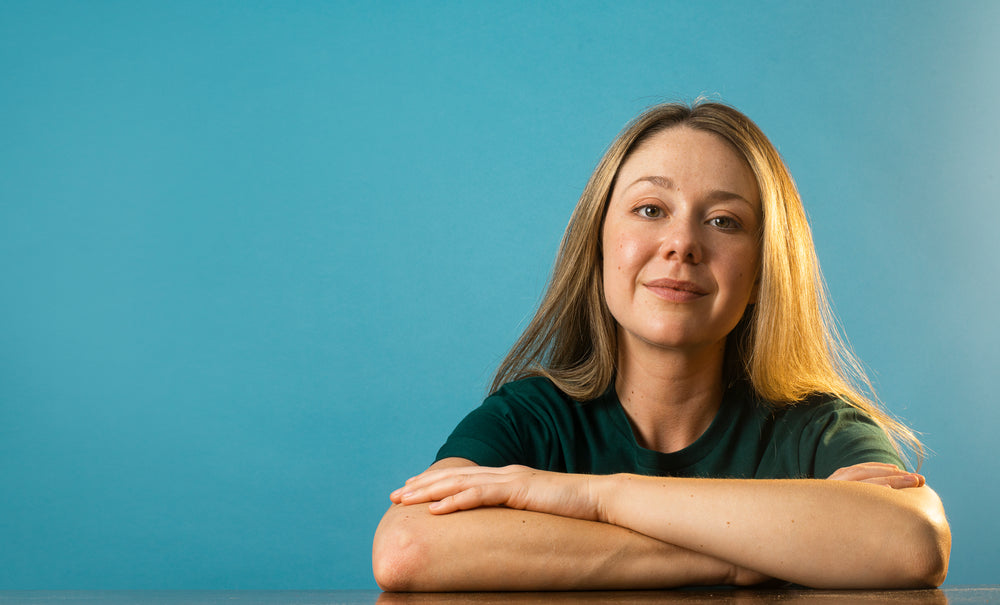 portrait of a woman with long brown hair and crossed arms