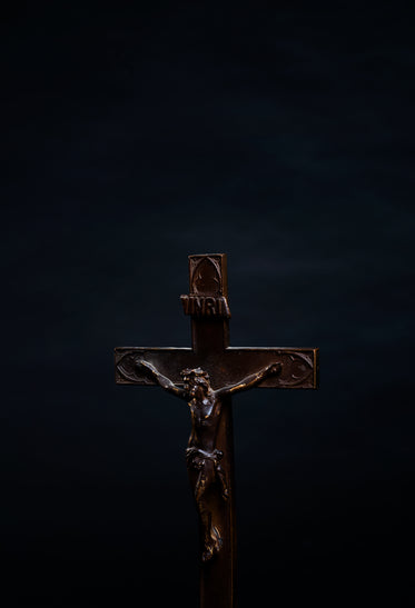 portrait of a wooden cross on black background