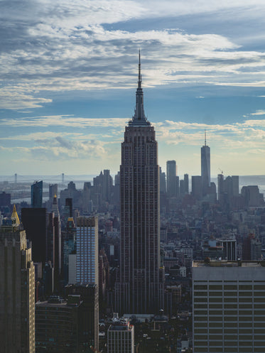 portrait of empire state building on cloudy day