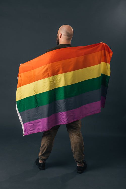portrait of man holding pride flag