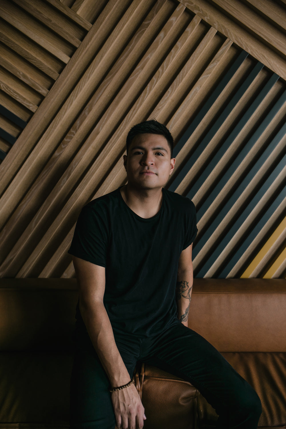 portrait of person in front of wooden wall