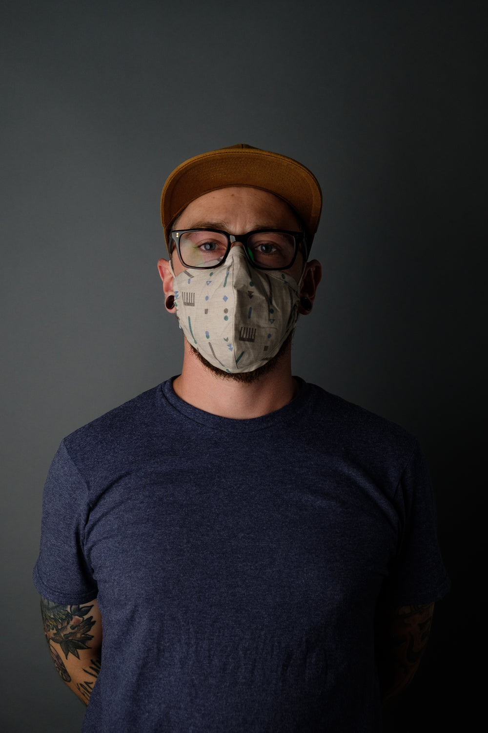 portrait of tattooed man wearing mask