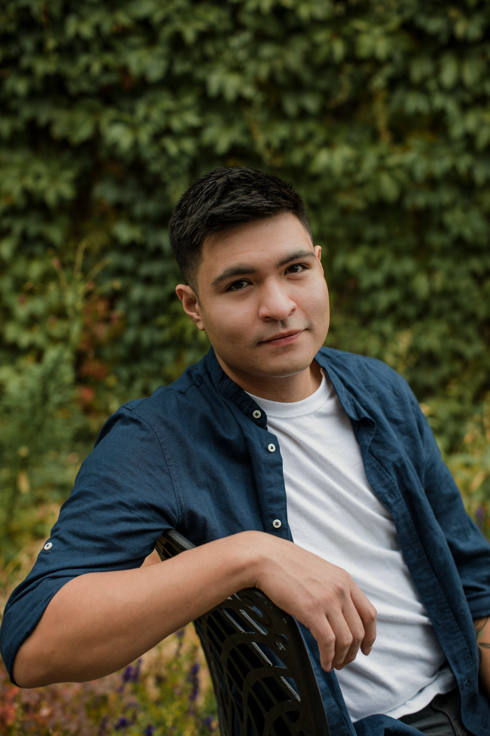 portrait of young man leaning on chair