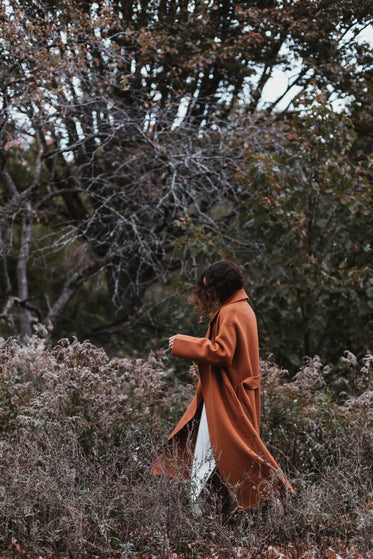 portrait of young woman in autumn colored coat