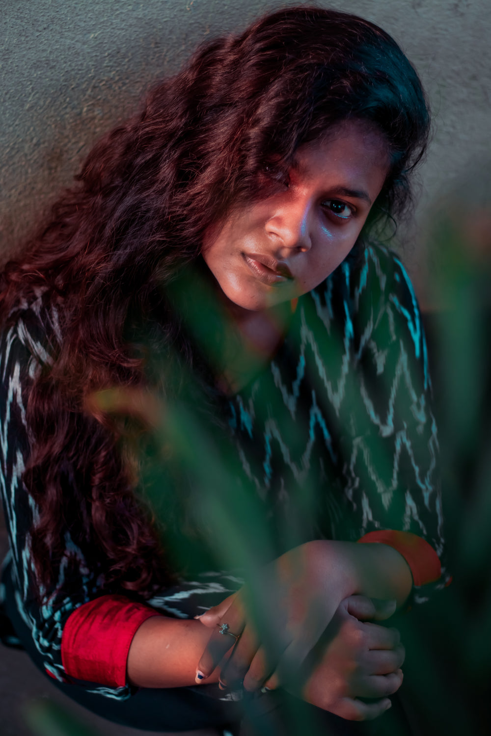 portrait taken through green leaves