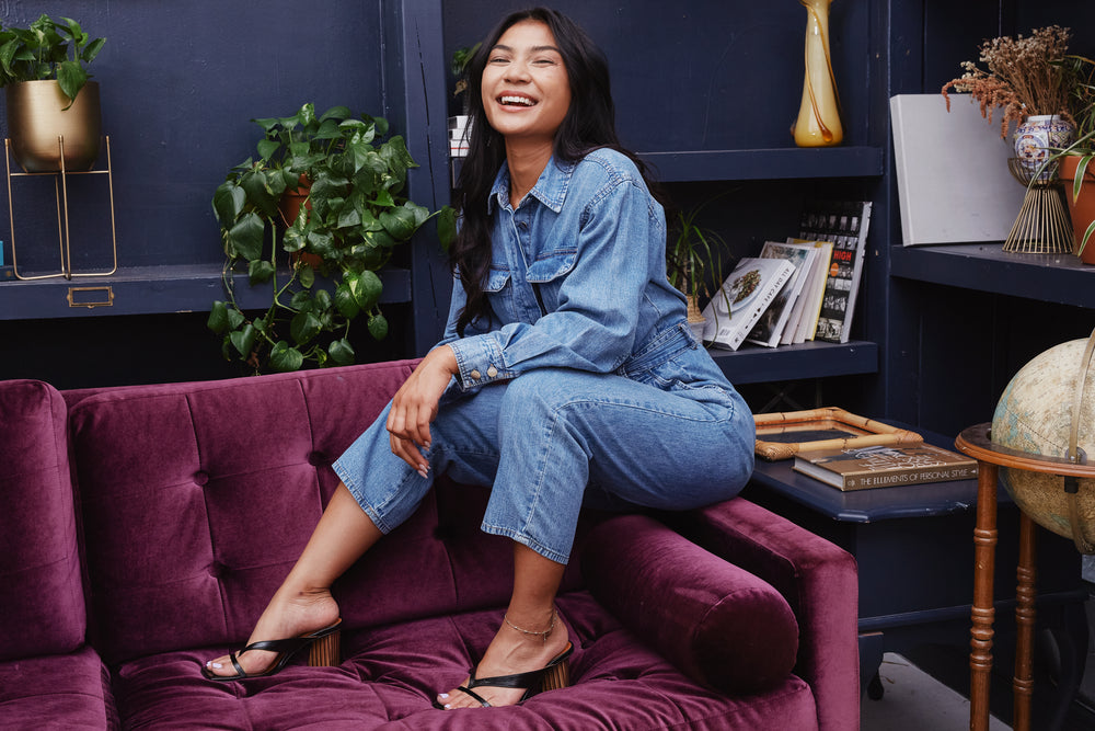 posing on arm of purple velvet couch