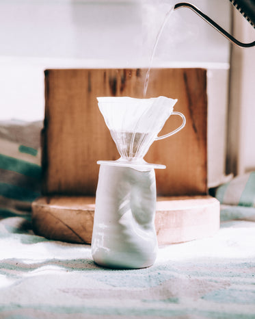 pour over coffee into unique ceramic vase