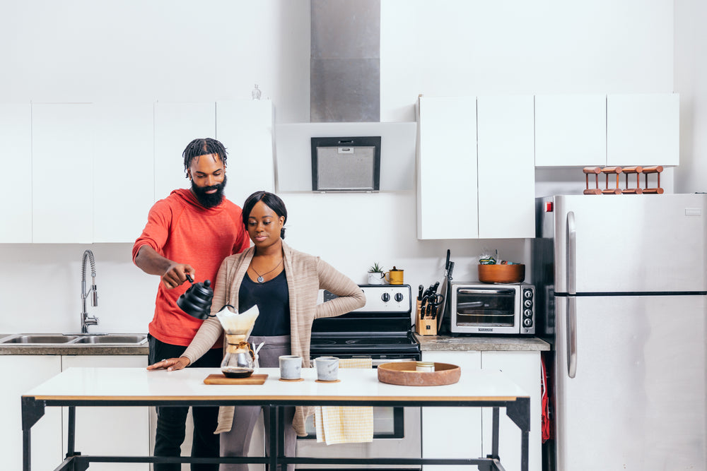 pouring coffee in a bright white kitchen