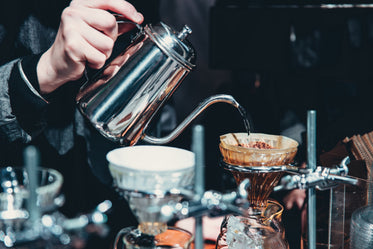 pouring hot water in cafe to make coffee