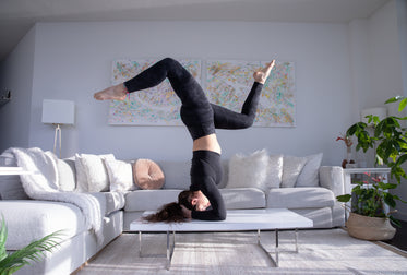 practicing yoga on their living room table