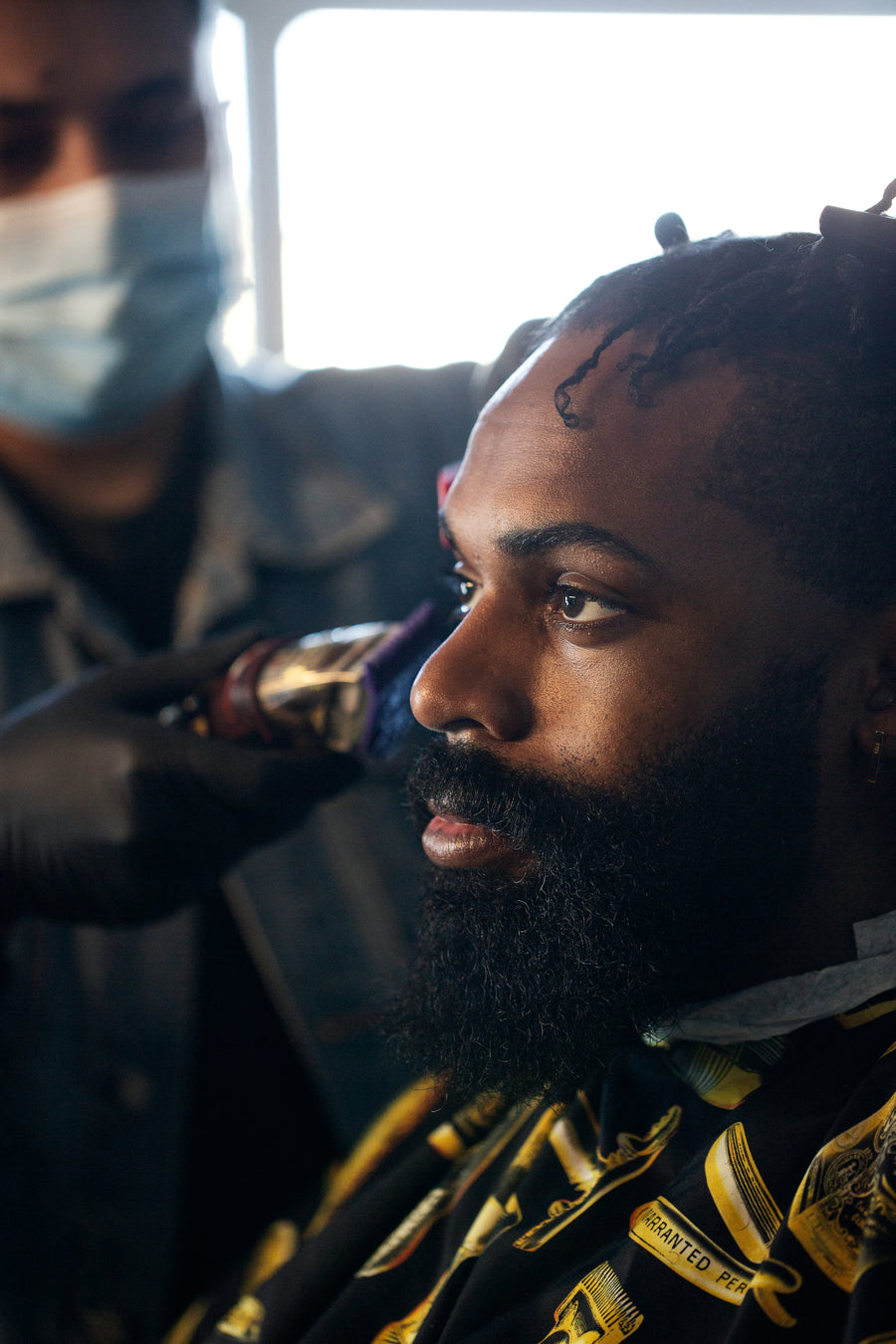 Profile of a man getting his hair cut