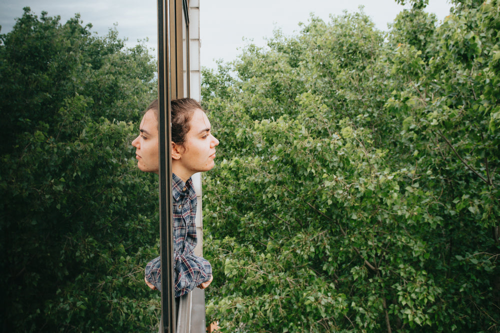 profile of a woman leaning out of an open window