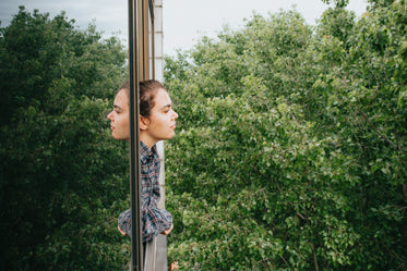 profile of a woman leaning out of an open window