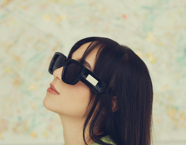 profile of a woman wearing bold black sunglasses