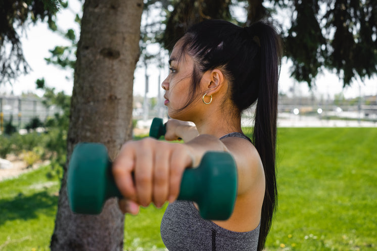 Profile Of A Woman Who Is Holding Hand Weights Outdoors