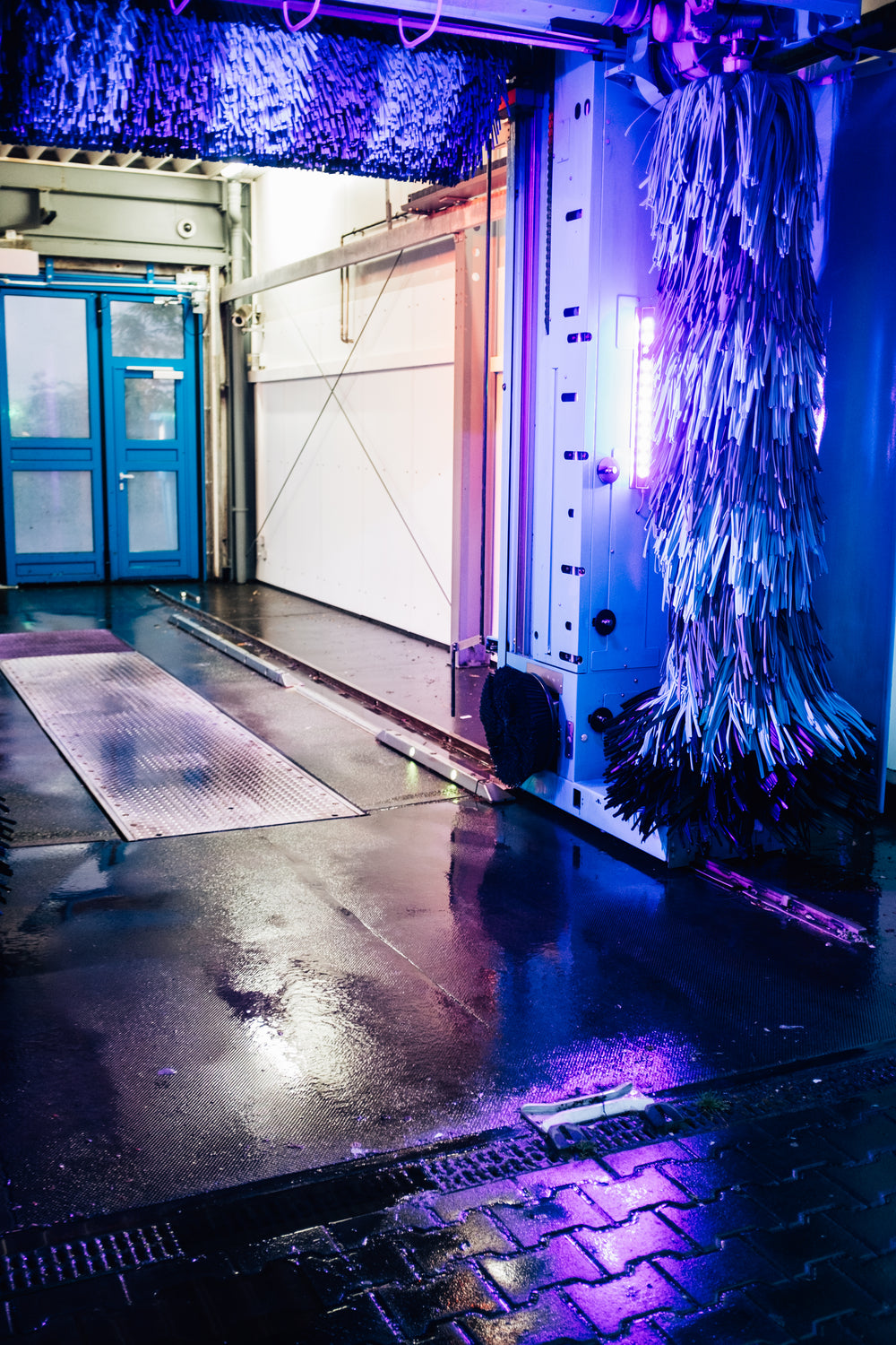 purple and blue light on the inside of a car wash