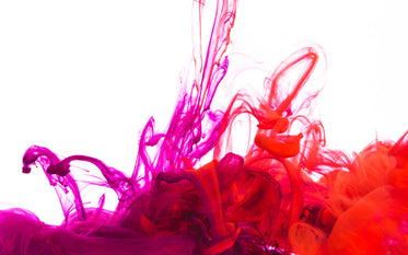 purple and red ink pool on white