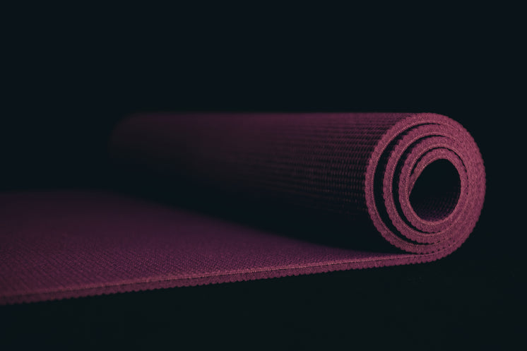 purple-yoga-mat-on-a-black-floor.jpg?wid