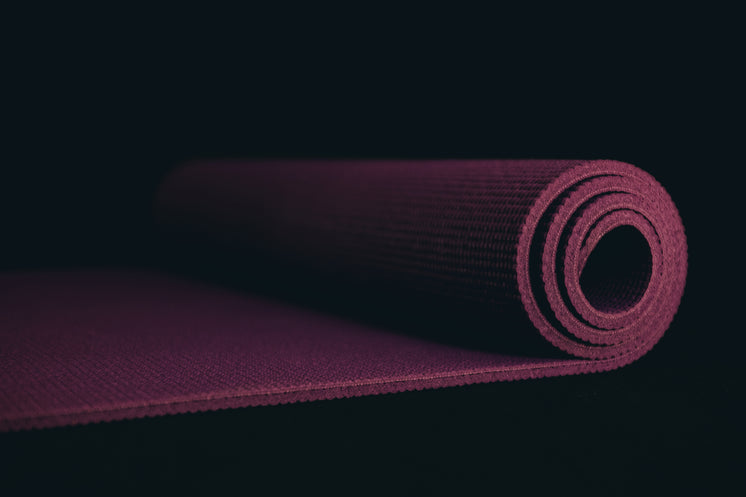 Purple Yoga Mat On A Black Floor