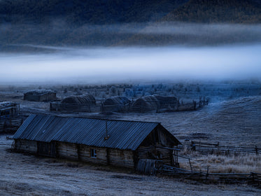 Quiet Wooden Farm With Low Clouds