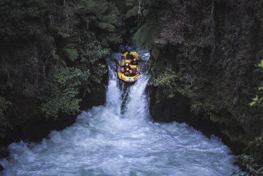 raft going down whitewater rapids