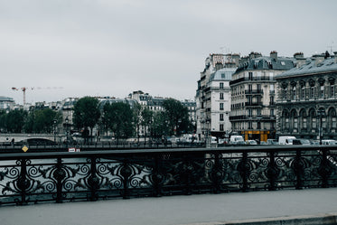 railing of a bridge and cityscape ahead