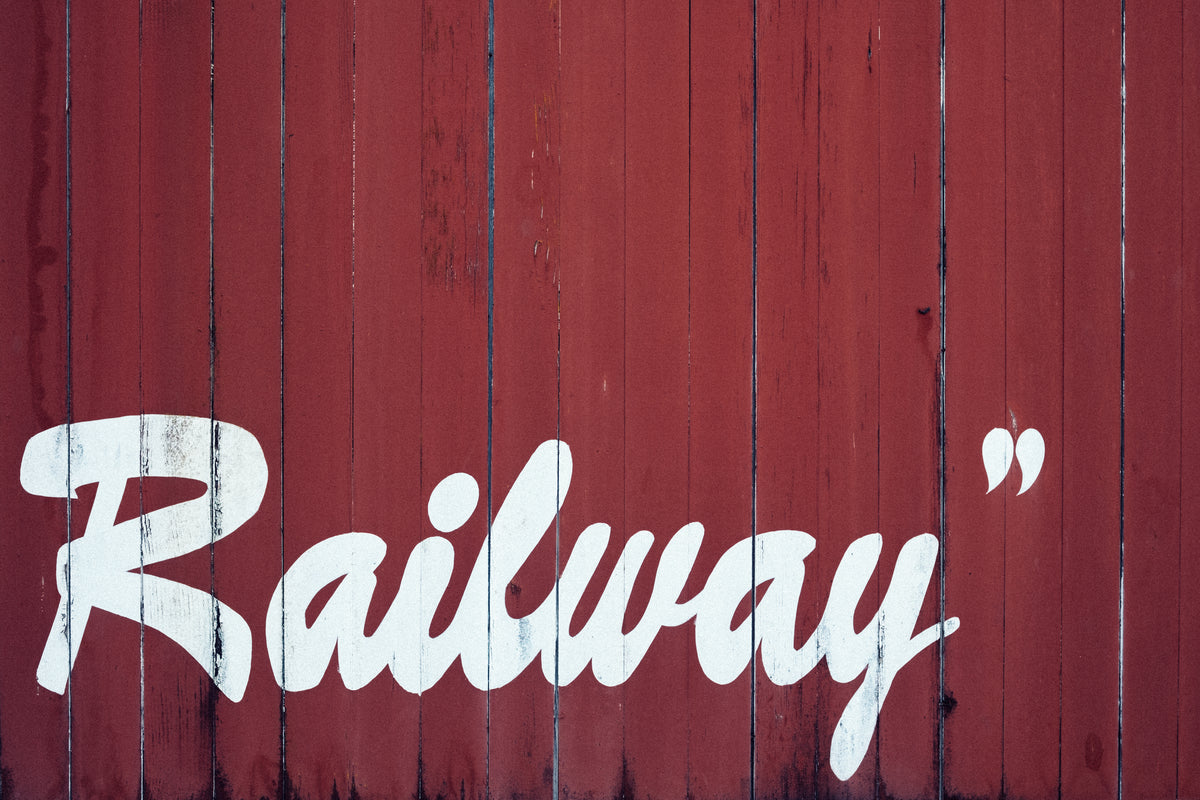 railway painted on red barnboard