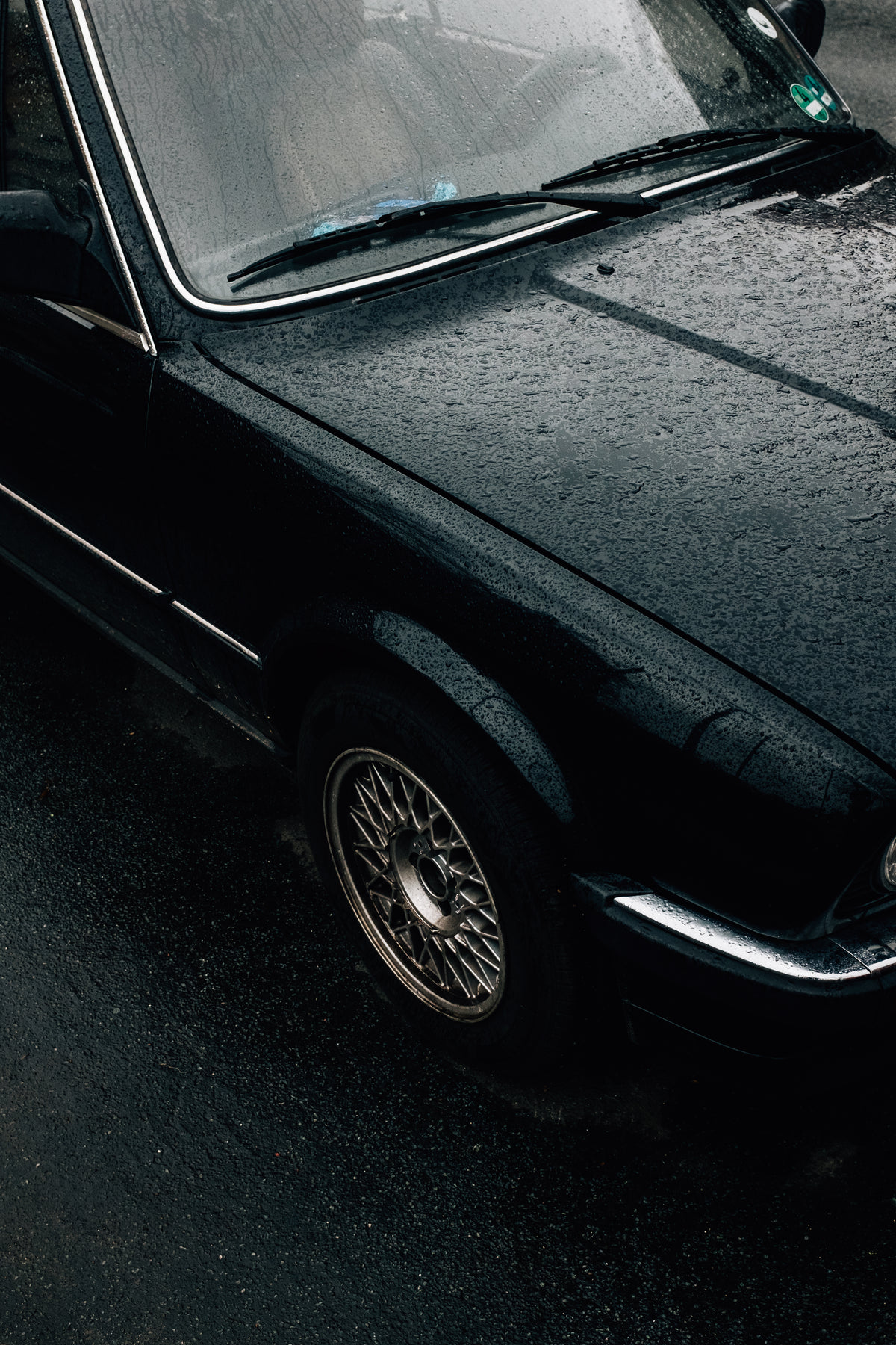rain-covered vintage car