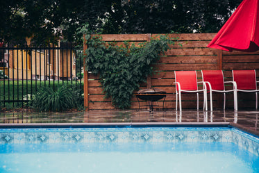 rain falls on clean pool and deck