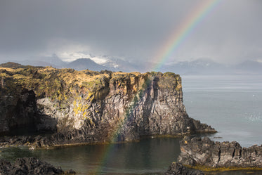 rainbow and rock cliff