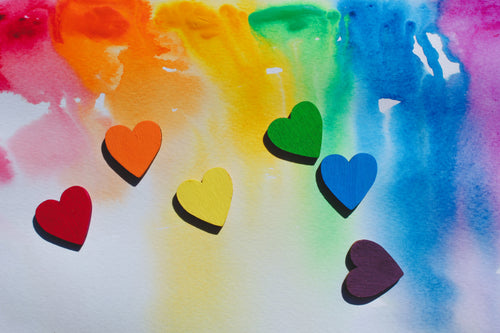 rainbow hearts scattered whimsically on watercolour canvas