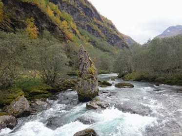 rapids rush downhill past rocks