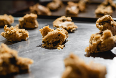 raw cookie dough in a silver baking tray